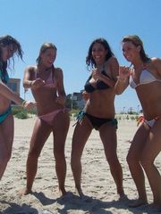 Hot busty brunette gets playful with her bikini friends