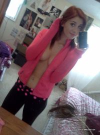 Photos of a sexy camwhoring amateur hottie showing her tits