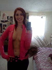 Photos of a sexy camwhoring amateur hottie showing her tits