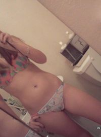 Teen blonde self-shooting nude in front of the mirror